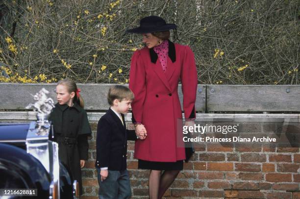 British royals Zara Phillips, Prince William and Diana, Princess of Wales , wearing a red coat with black lapels and a black hat, attend the Easter...