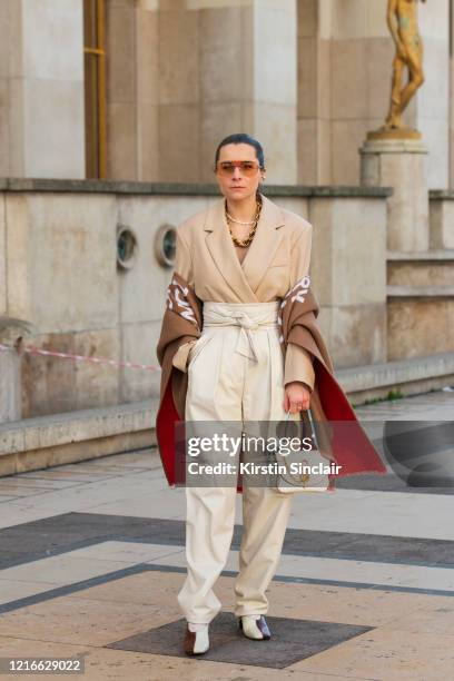 Digital influencer Julia Comil wears a Kristina Fidelskaya jacket and trousers, Wandler shoes, Burberry wool wrap, Ferragamo sunglasses and a JW...