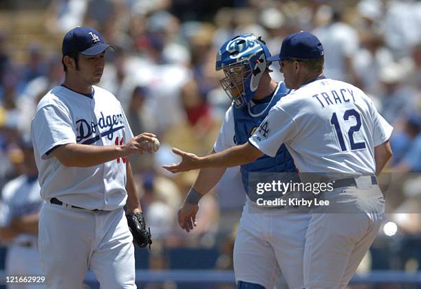 Los Angeles Dodgers starter Hideo Nomo is removed by manager Jim Tracy in the second inning against the Chicago Cubs at Dodger Stadium in Los Angeles...