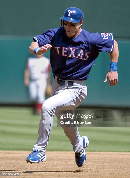 Laynce Nix of the Texas Rangers rounds third base en route to scoring on a double by Rod Barajas in the third inning of 2-0 victory over the Anaheim...