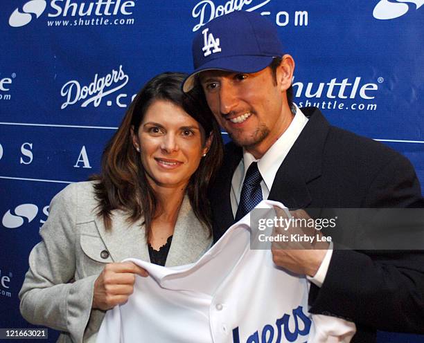 Nomar Garciaparra and his wife Mia Hamm pose with Los Angeles Dodger jersey at press conference to announce his signing to a one-year contract at...