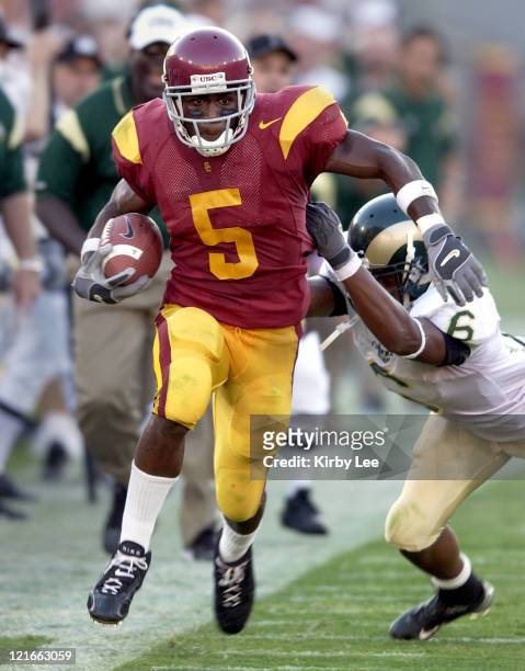 Sophomore tailback Reggie Bush tries to elude Robert Herbert of Colorado State in the second quarter of 49-0 victory at the Los Angeles Memorial...