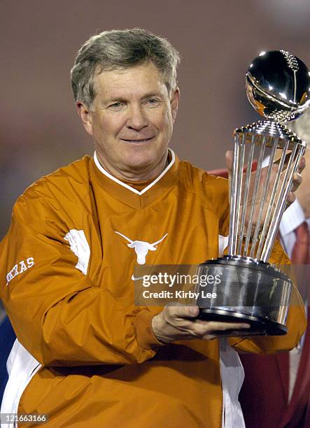 Texas coach Mack Brown holds Rose Bowl championship trophy after 38-37 victory over Michigan in the 91st Rose Bowl in Pasadena, Calif. On Saturday,...