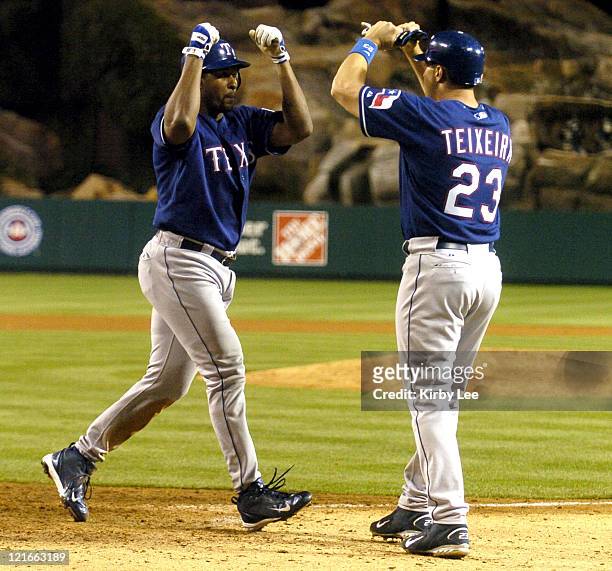Richard Hidalgo and Mark Teixeira of the Texas Rangers celebrate after Hidalgo's solo home run in the eighth inning of 3-2 victory in 12 innings over...