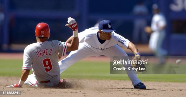 Tomas Perez of the Philadelphia Phillies slides safely into second base beneath tag of Alex Cora during 4-1 victory at Dodger Stadium on Sunday,...