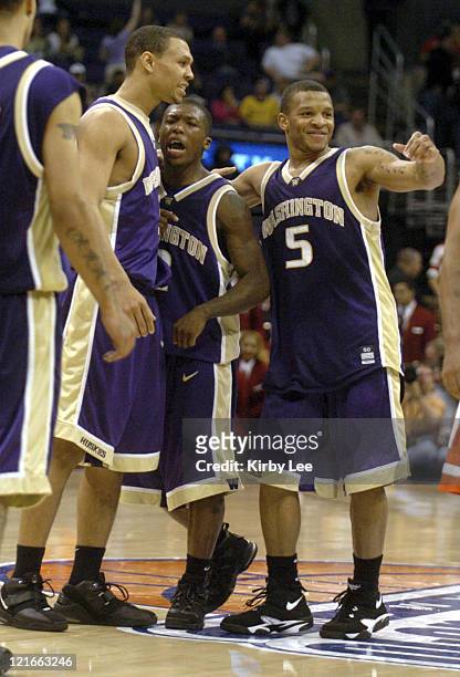 Brandon Roy, Nate Robinson and Will Conroy of Washington celebrate 81-72 victory over Arizona in the Pacific Life Pac-10 Tournament Championship at...