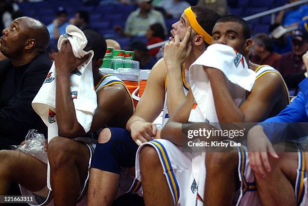 Players Arron Afflalo, Michael Ffefy and Josh Shipp sit on the bench dejectedly in the final minute of 79-72 first-rouond loss to Oregon State in the...