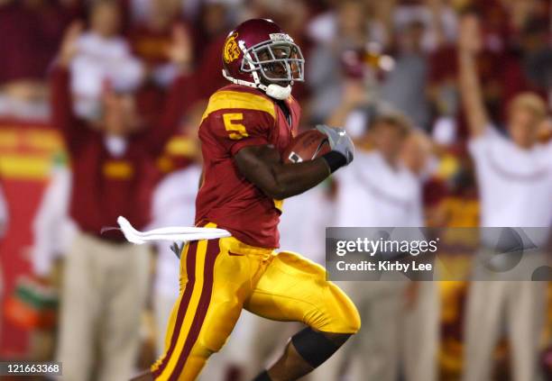 Junior tailback Reggie Bush scores on a 76-yard run in the first quarter of 70-17 victory over Arkansas at the Los Angeles Memorial Coliseum on...
