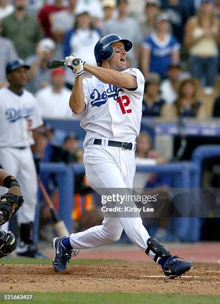 Steve Finley of the Los Angeles Dodgers hits a grand-slam home run in the bottom of the ninth inning in 7-3 victory over the San Francisco Giants to...