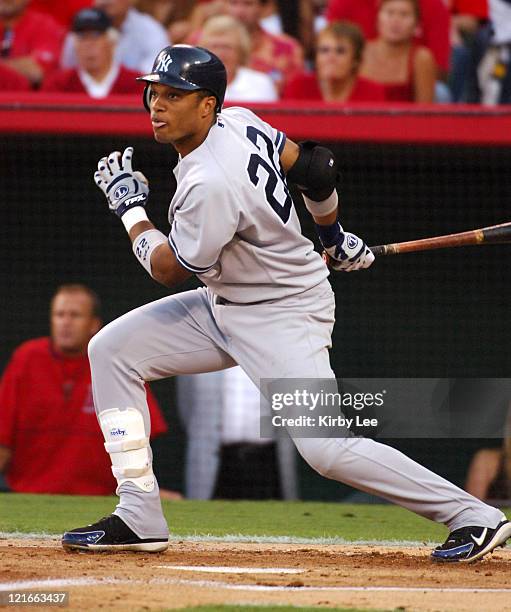 Robinson Cano of the New York Yankees hits a three-run double in his first postseason at bat in the first inning of 4-2 victory over the Los Angeles...