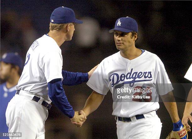 Los Angeles Dodgers manager Jim Tracy shakes hands with Robin Ventura after 12-2 victory over the San Diego Padres at Dodger Stadium in Los Angeles,...