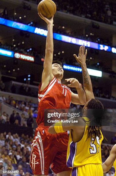 Yao Ming of the Houston Rockets shoots over Brian Grant of the Los Angeles Lakers during the NBA game between the Los Angeles Lakers and the Houston...