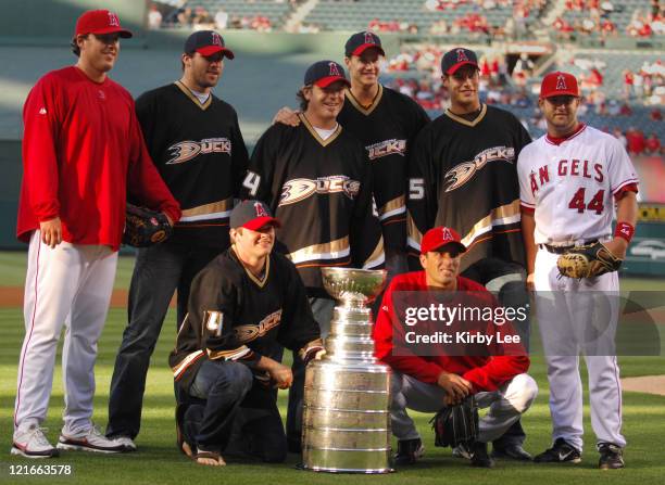 Members of the NHL Stanley Cup-winning Anaheim Ducks, second left, Dustin Penner, Chris Kunitz, kneeling, Brad May, Chris Pronger and Ryan Getzlaf...