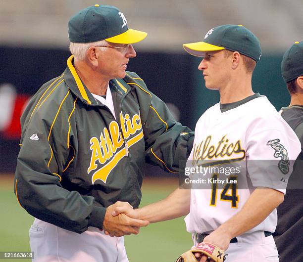 Oakland Athletics manager Ken Macha congratulates Mark Ellis after 13-6 victory over the Boston Red Sox at McAfee Coliseum in Oakland, Calif. On...