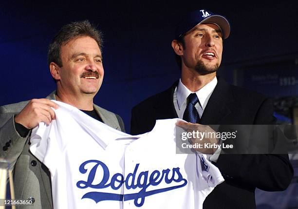 Los Angeles Dodgers general manager Ned Colletti and Nomar Garciaparra pose at press conference to announce signing of Garciaparra to a one-year...