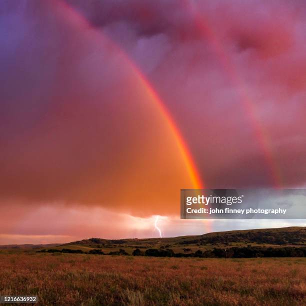 stormy sunset with a rainbow and lightning near the town of big timber, montana. usa - big dreams stockfoto's en -beelden