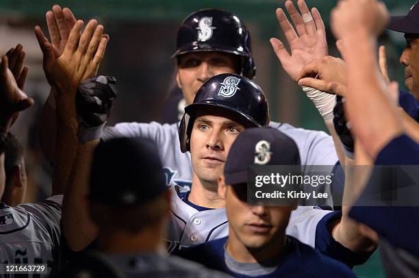 Ben Broussard of the Seattle Mariners is congratulated by teammates after hittiing a two-run home run in the fifth inning of 9-7 loss to the Los...