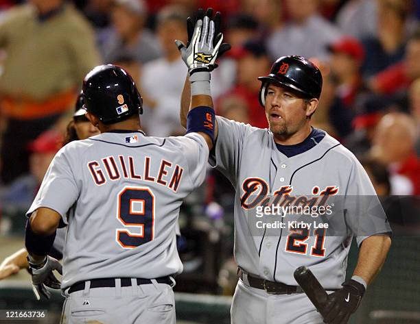 Carlos Guillen of the Detroit Tigers is congratulated by Sean Casey after scoring in the second inning of Major League Baseball game against the Los...