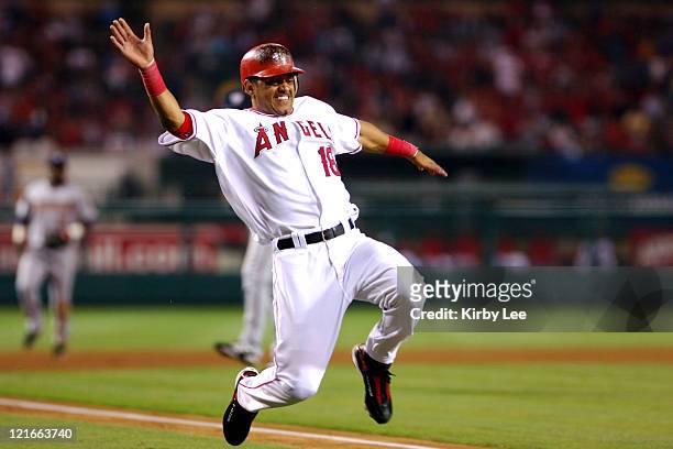 Orlando Cabrera of the Los Angeles Angels of Anaheim slides safely into home plate to score in the sixth inning of 5-3 loss to the Washington...