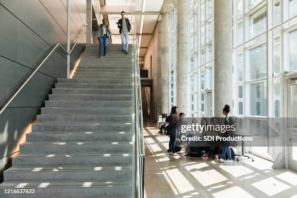 college students descend indoor staircase - campus stock pictures, royalty-free photos & images