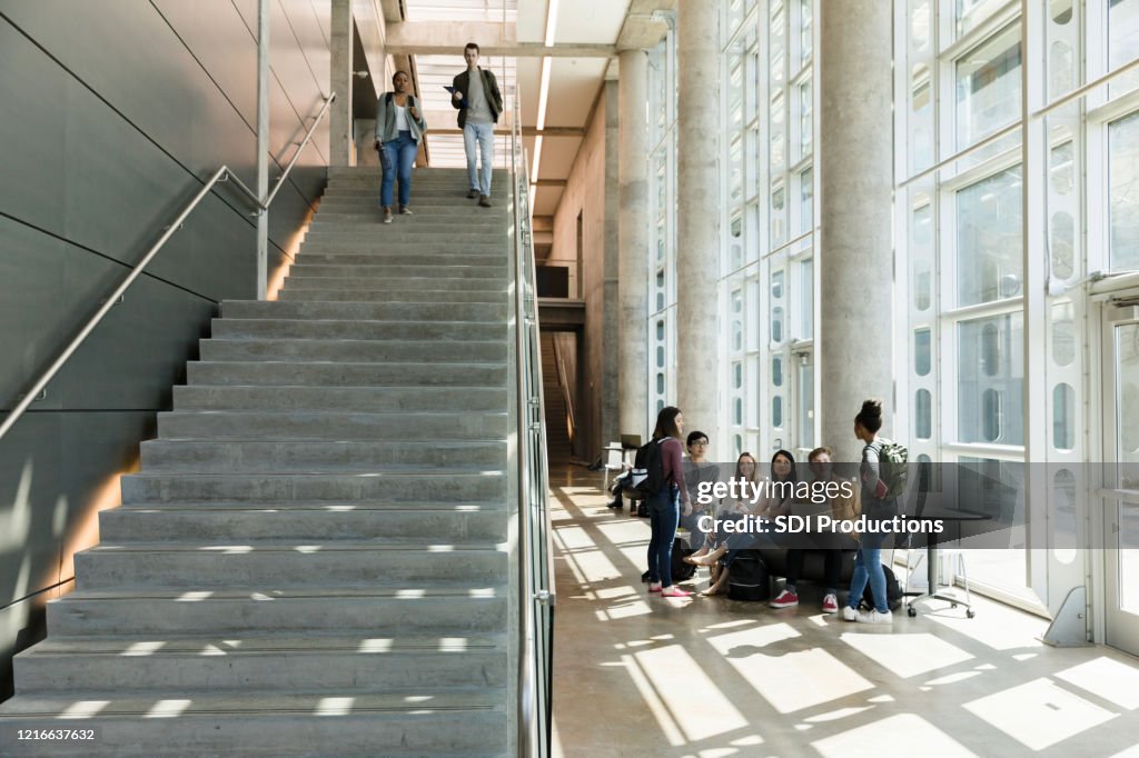 College students descend indoor staircase