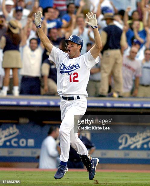 Steve Finley of the Los Angeles Dodgers celebrates after hitting a grand-slam home run in the bottom of the ninth inning in 7-3 victory over the San...