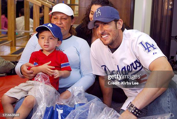 Nomar Garciaparra of the Los Angeles Dodgers poses with 26-month old Chris Velasquez and his mother Lorena Bugarin during a visit to the White...