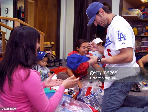 Nomar Garciaparra of the Los Angeles Dodgers signs autographs during a visit to the White Memorial Medical Center Pediatric Unit in Los Angeles,...