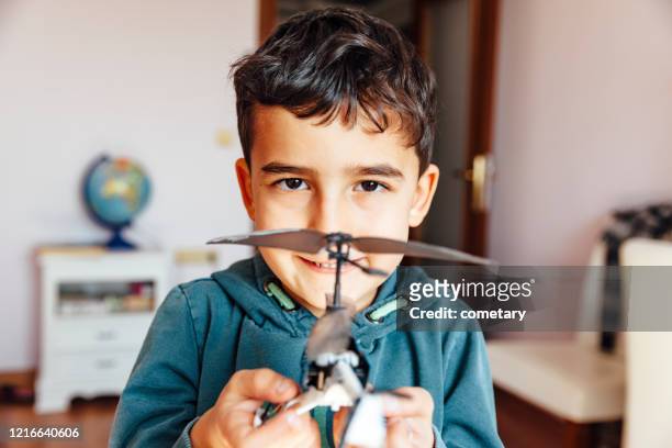 child holding helicopter toy - toy helicopter stock pictures, royalty-free photos & images