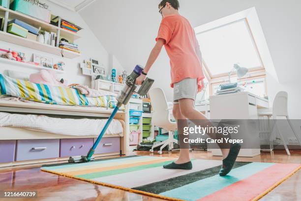low section male teenager with vacuum cleaner bedroom - boy bedroom stock pictures, royalty-free photos & images