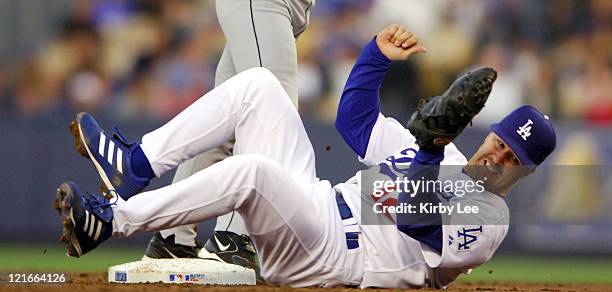 Jeff Kent of the Los Angeles Dodgers falls backward after tagging out Ivan Rodriguez at second base in the second inning of 8-4 loss at Dodger...