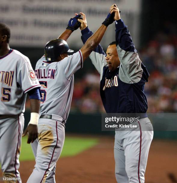 Jose Guillen of the Washington Nationals exchanges high five with Wil Cordero after hitting a two-run home run in the eighth inning of 5-3 victory...