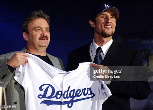 Los Angeles Dodgers general manager Ned Colletti and Nomar Garciaparra pose at press conference to announce signing of Garciaparra to a one-year...