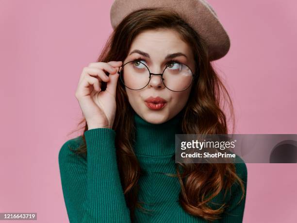 smart and decent girl thinking about something - eyewear stock-fotos und bilder