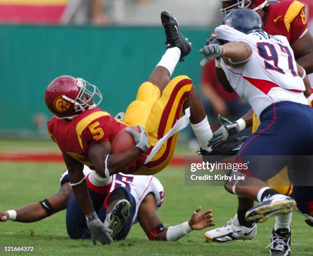 Running back Reggie Bush is upended during 42-21 victory over Arizona in Pacific-10 Conference football game at the Los Angeles Memorial Coliseum on...