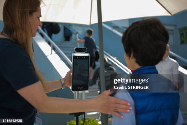 Student stands in front of a touchless Biometrics with Body Temperature Detection device in a primary school in Thessaloniki on June 1 as Greece...