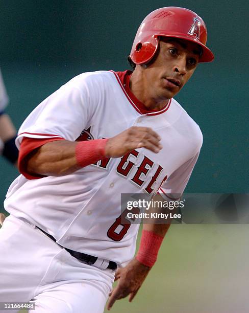 Maicer Izturis of the Los Angeles Angels of Anaheim rounds third base to score in the first inning of 10-5 victory over the Cleveland Indians at...