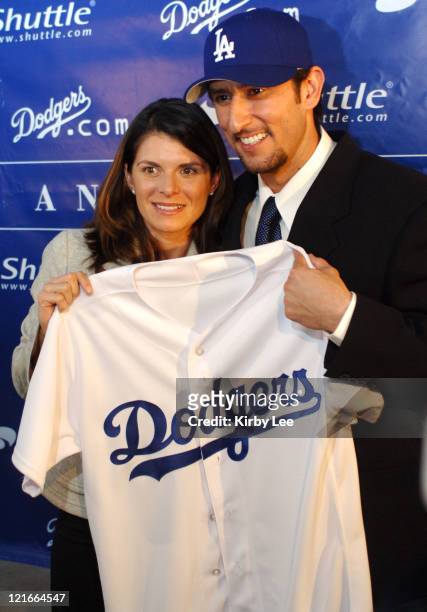 Nomar Garciaparra and his wife Mia Hamm pose with Los Angeles Dodger jersey at press conference to announce his signing to a one-year contract at...