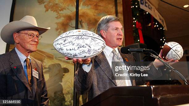 Texas coach Mack Brown presents autographed Longhorns footballs to Lawry's Restaurants, Inc. Chairman Richard N. Frank at the 50th Lawry's Beef Bowl...