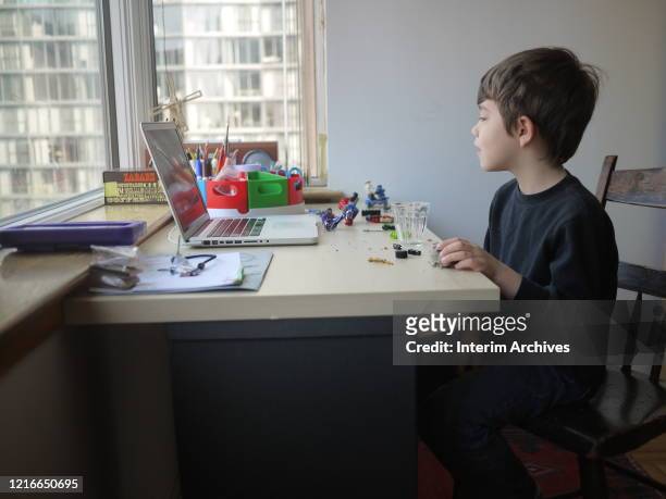 Young boy participates in an online lesson for his kindergarten class while schools remain closed to help slow the spread of COVID-19, Chicago,...