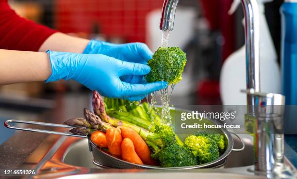 disinfecting groceries during covid-19 coronavirus outbreak - surgical glove stock pictures, royalty-free photos & images