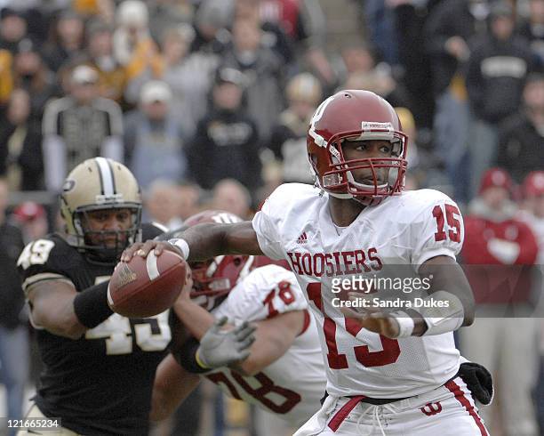 Indiana QB Kellen Lewis prepares to pass as Purdue's Anthony Spencer closes in. Purdue defeated Indiana 28-19 in Ross Ade Stadium, West Lafayette,...