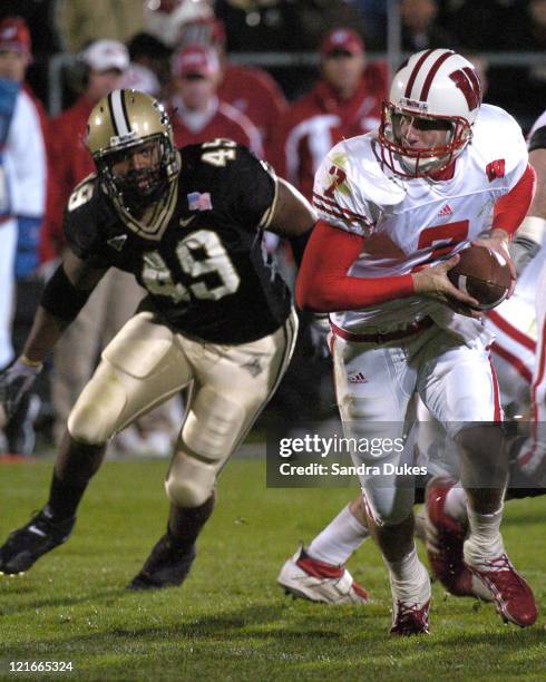 Wisconsin's John Stocco looks to hand off as Anthony Spencer closes in in Wisconsin's 20-17 win over Purdue in Ross Ade Stadium.