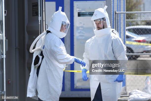 Technicians in protective clothing do a dry run at Battelle's Critical Care Decontamination System, which has been deployed at Stony Brook...