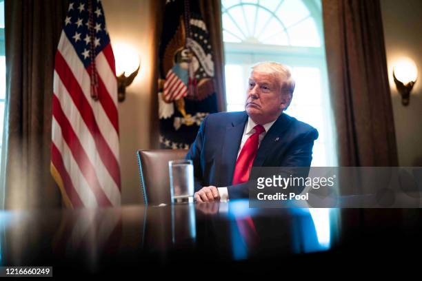 President Donald Trump listens during a roundtable meeting with energy sector CEOs in the Cabinet Room of the White House April 3, 2020 in...