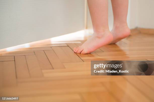 cute child feet, toddler trying to reach door handle - kids feet in home stock pictures, royalty-free photos & images