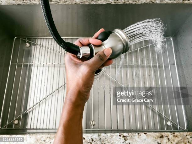 woman rinses kitchen sink - wet hose ストックフォトと画像