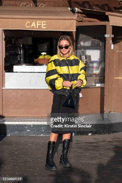 Digital influencer Nina Suess wears a Saint Laurent bag and sunglasses, Prada boots and a Rochas dress and jacket on February 26, 2020 in Paris,...