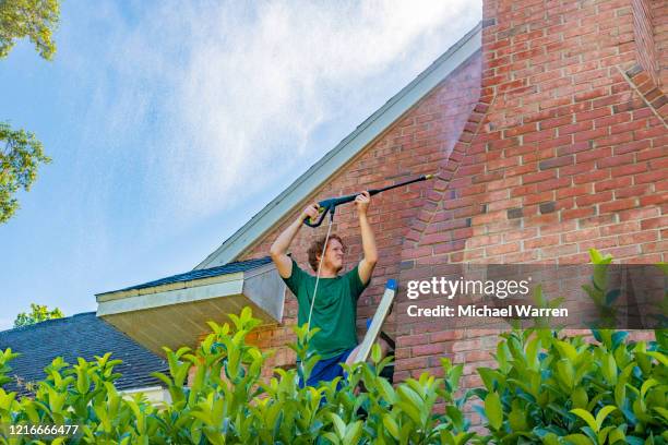 pressure washing a brick house - brick house stock pictures, royalty-free photos & images
