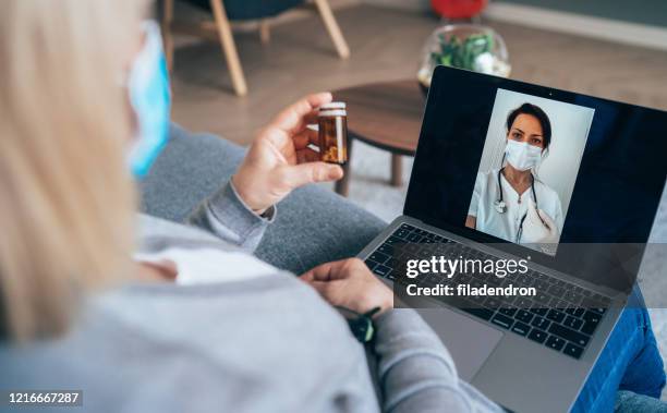 video call with doctor - over the shoulder view patient stock pictures, royalty-free photos & images